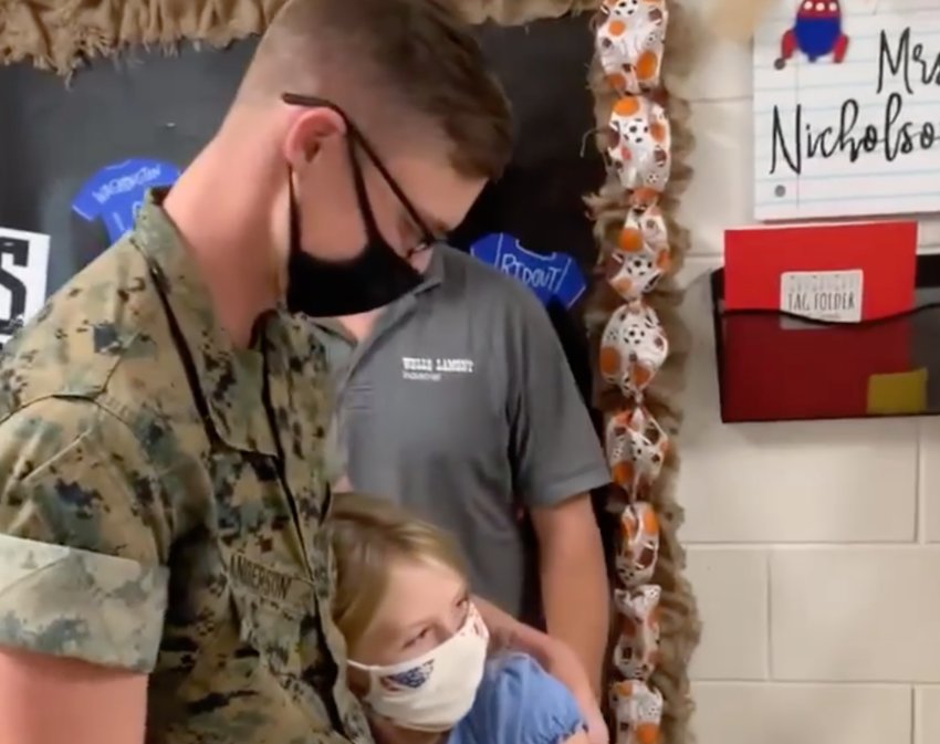 Hallie Anderson hugs her brother, U.S. Marine Austin Anderson, after a surprise visit.